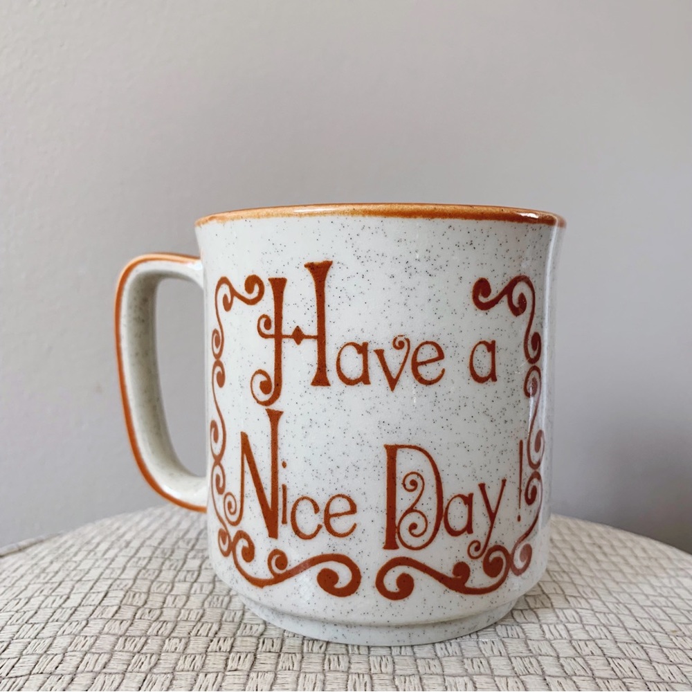 Vintage mug w/ caramel scroll, handle, rim, and text - reads “Have a Nice Day!”